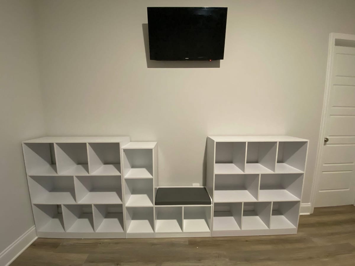 Cube storage shelving wall with mounted TV