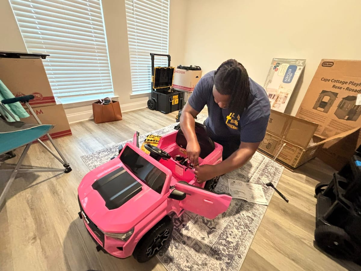 Reuben assembling a kids' ride-on truck